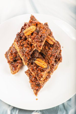 Golden crunchy fresh baked pecan diamond cookies made on a rich short dough.の写真素材