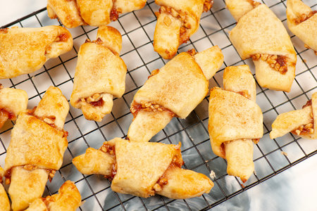 Rugelach cookies made on a cream cheese dough with strawberry jam, mixed nuts topped with cinnamon sugar.の写真素材