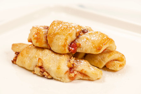 Rugelach cookies made on a cream cheese dough with strawberry jam, mixed nuts topped with cinnamon sugar.の写真素材