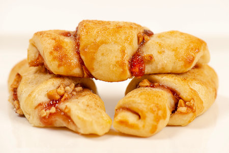 Rugelach cookies made on a cream cheese dough with strawberry jam, mixed nuts topped with cinnamon sugar.の写真素材