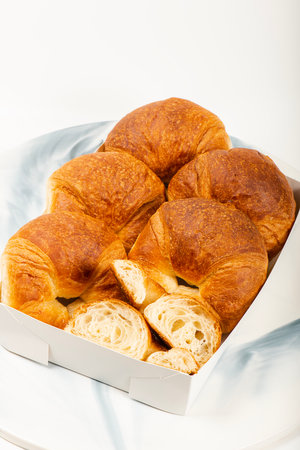 Freshly baked golden brown plain butter croissants.の写真素材