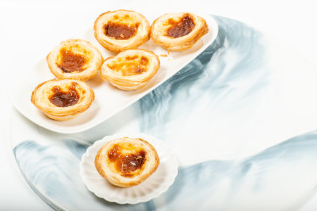 Delectable golden baked and flakey Portuguese custard tartsの写真素材