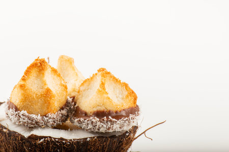 Fresh homemade delicious coconut macaroons dipped in milk chocolate and shredded coconut.の写真素材