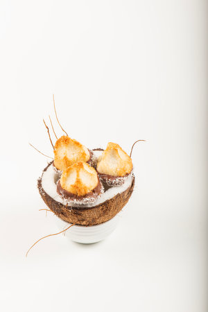 Fresh homemade delicious coconut macaroons dipped in milk chocolate and shredded coconut.の写真素材