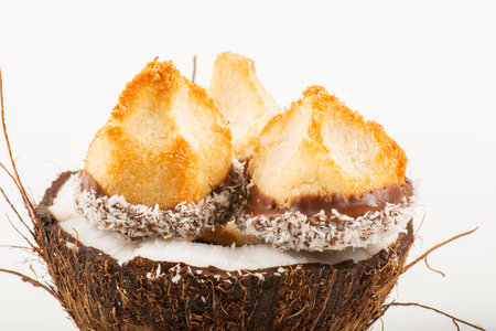 Fresh homemade delicious coconut macaroons dipped in milk chocolate and shredded coconut.の写真素材