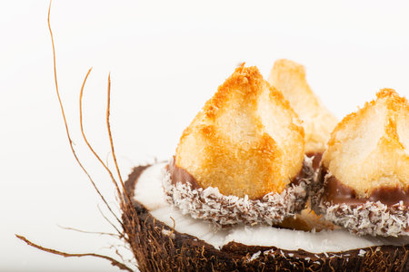 Fresh homemade delicious coconut macaroons dipped in milk chocolate and shredded coconut.の写真素材