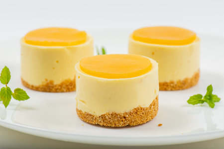 Creamy petite mango cheesecake with mango jelly and a wholewheat biscuit crumb base.の写真素材