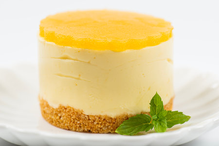 Creamy petite mango cheesecake with mango jelly and a wholewheat biscuit crumb base.の写真素材
