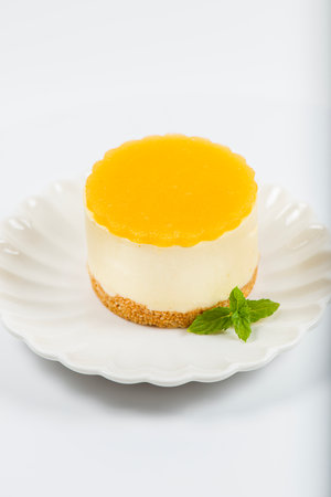 Creamy petite mango cheesecake with mango jelly and a wholewheat biscuit crumb base.の写真素材