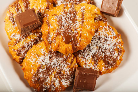 Fresh-baked Snickerdoodle cookies with chocolate and shredded coconut.の写真素材