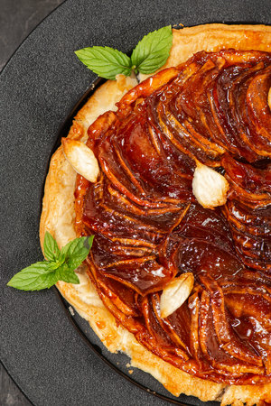 Delicious apple Tarte Tatin with sweet red apple, caramel and puff pastryの写真素材