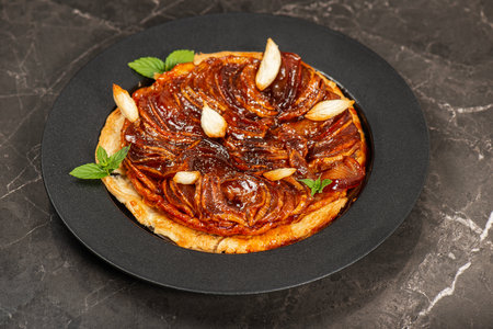 Delicious apple Tarte Tatin with sweet red apple, caramel and puff pastryの写真素材