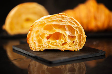 Detailed close-up of crispy, flaky, and delicious butter croissantsの写真素材