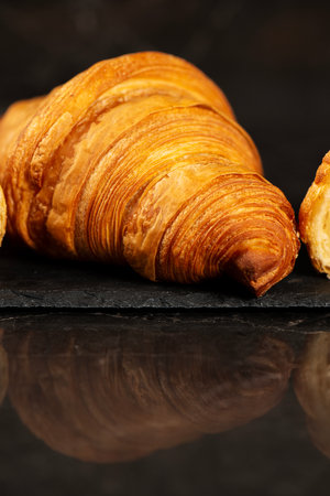 Detailed close-up of crispy, flaky, and delicious butter croissantsの写真素材