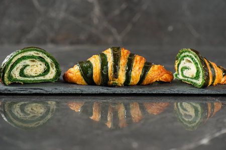 Detailed close-up of crispy, flaky, and delicious bicolour croissant.の写真素材