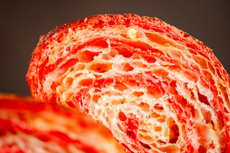 Detailed close-up of crispy, flaky, and delicious hand-laminated bicolour chilli-flavoured croissant.の写真素材