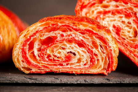 Detailed close-up of crispy, flaky, and delicious hand-laminated bicolour chilli-flavoured croissant.の写真素材