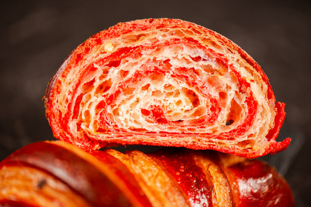 Detailed close-up of crispy, flaky, and delicious hand-laminated bicolour chilli-flavoured croissant.の写真素材