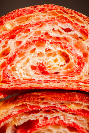 Detailed close-up of crispy, flaky, and delicious hand-laminated bicolour chilli-flavoured croissant.の写真素材