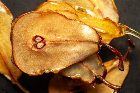 Candied pear chips, first dehydrated and then dipped in a caramel sugar solution and left to dry.の写真素材