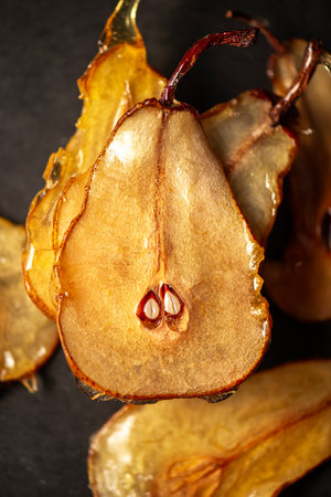 Candied pear chips, first dehydrated and then dipped in a caramel sugar solution and left to dry.の写真素材