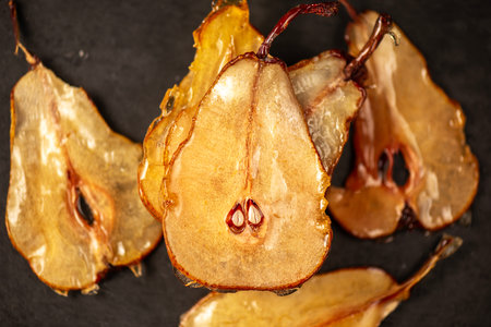 Candied pear chips, first dehydrated and then dipped in a caramel sugar solution and left to dry.の写真素材