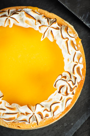 Lemon Meringue Pie made with shortcrust pastry, lemon curd, and torched Italian meringue.の写真素材