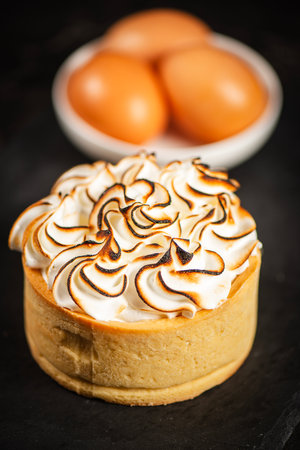 Lemon Meringue Pie made with shortcrust pastry, lemon curd, and torched Italian meringue.の写真素材
