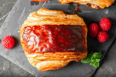 Delectable golden brown baked Pain au chocolat with fresh summer fruit.の写真素材