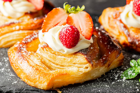 Delicious flaky fresh baked Danish Pastry with Chantilly cream and fresh fruit.の写真素材