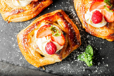Delicious flaky fresh baked Danish Pastry with Chantilly cream and fresh fruit.の写真素材