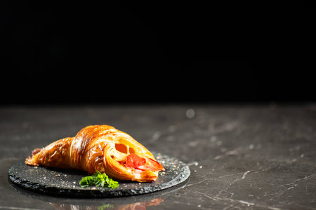 Viennoiserie pastry filled with smoked and baked fresh ham off the bone and tasty cheese.の写真素材