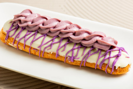 Golden baked choux pastry filled with Ube pastry cream and decorated with colored white chocolate.