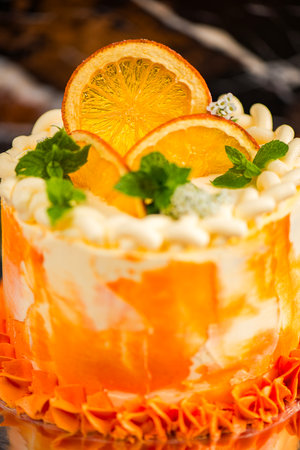 Quatre-quarts Cake also known as French Pound Cake, with a soft chocolate fudge insert, watercolor two-toned American buttercream, flower, and dehydrated orange decoration.の写真素材