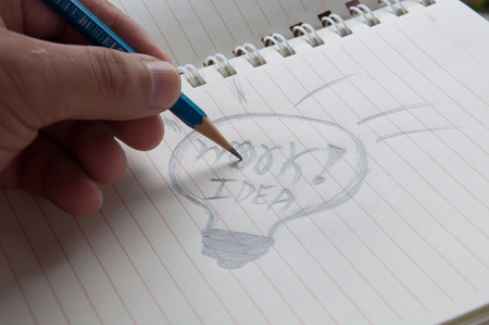 Businessman hand drawing and idea for making money on the book.の写真素材