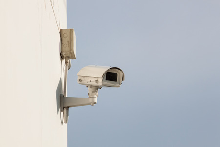 Security camera on wall of building