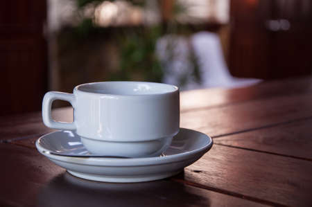 A cup of coffee on wooden backgroundの写真素材