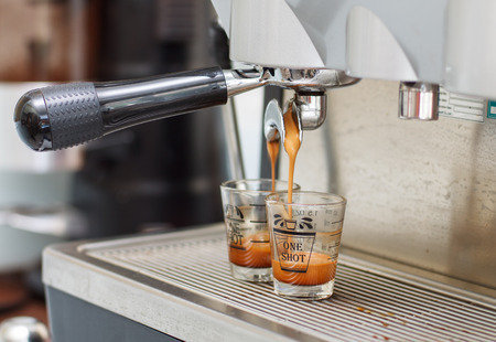 Espresso coffee machine, Coffee is pouring in a glass of coffee machine.の写真素材