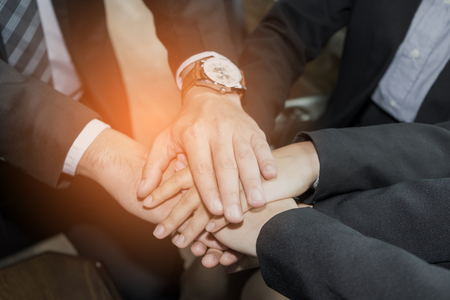 business people join hand while meeting in office. business working concept and success.