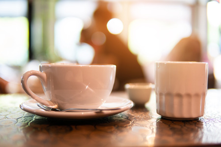 Hot art Latte Coffee in a cup on wooden table in Coffee shop blur background. business time and...