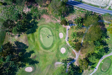 Aerial view photography of forest and golf course with lake. Golf and sport club.の写真素材