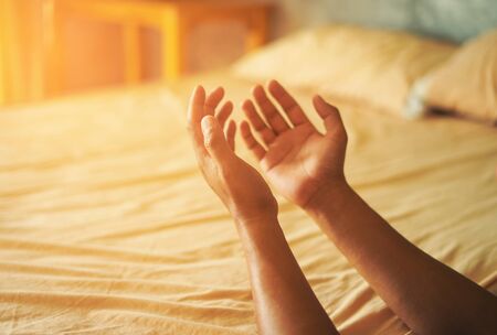 Christian hands raised to worship for bless God with good fortune in his bedroom. Eucharist Therapy Bless God Helping Repent Catholic Easter Lent Mind Pray. fighting and victory for god.の写真素材