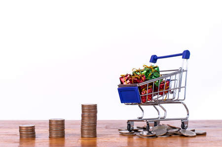 Stack coin with shopping cart or trolley, Excessive shopping causes financial problems, lavish...
