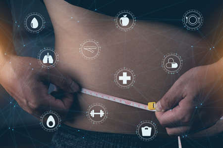 Fat mature man measuring his belly with measurement tape with virtual health  illustration icons.の写真素材