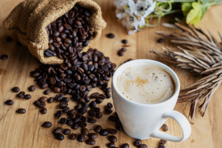 Hot coffee espresso or americano and coffee bean on older wood table at morning time. Coffee break...