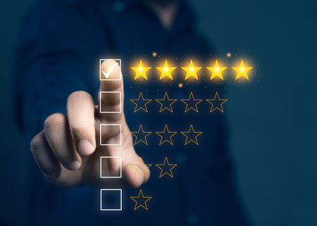Businessman touching glowing yellow five stars for excellent evaluation after customer use product service. Customer review: good rating concept. feedback and positive customer reviews.の写真素材