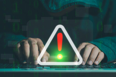 A businessman is using a computer with a triangle caution warning sign for notification error and maintenance concept. cybercrime, security, ransomware.の写真素材