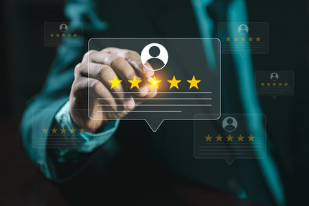 Online customer satisfaction survey service, The customer is hand-press on the smartphone with gold five-star rating feedback icon and pressing excellent rank to give the best score point for reviewの写真素材