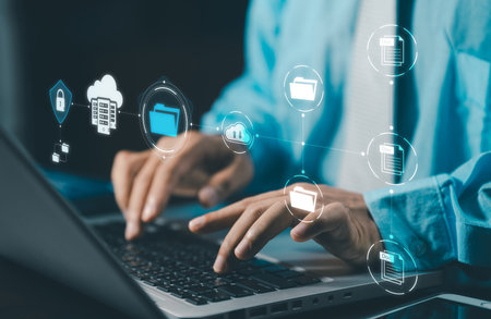 DMS Document Management System concept. Data storage. Businessman using a tablet and touching folder icon to search on databases with virtual screen. documents digital for corporate businesses.の写真素材