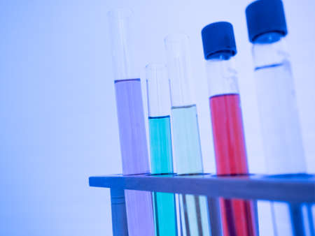 The test tube has a multicolored liquid inside. Put on a table for science experiments, color tones. close-up and selective focus.の写真素材